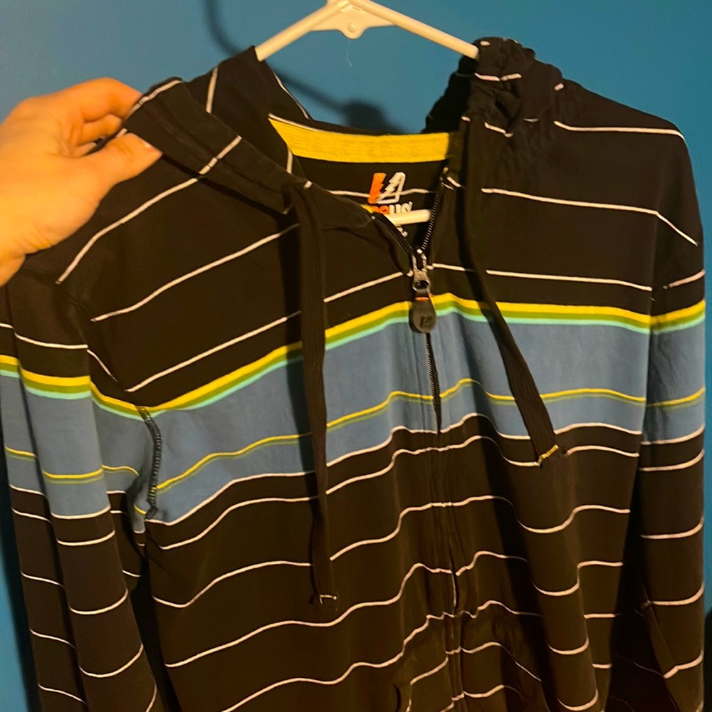 Small black hoodie with white lines & blue, green yellow stripes